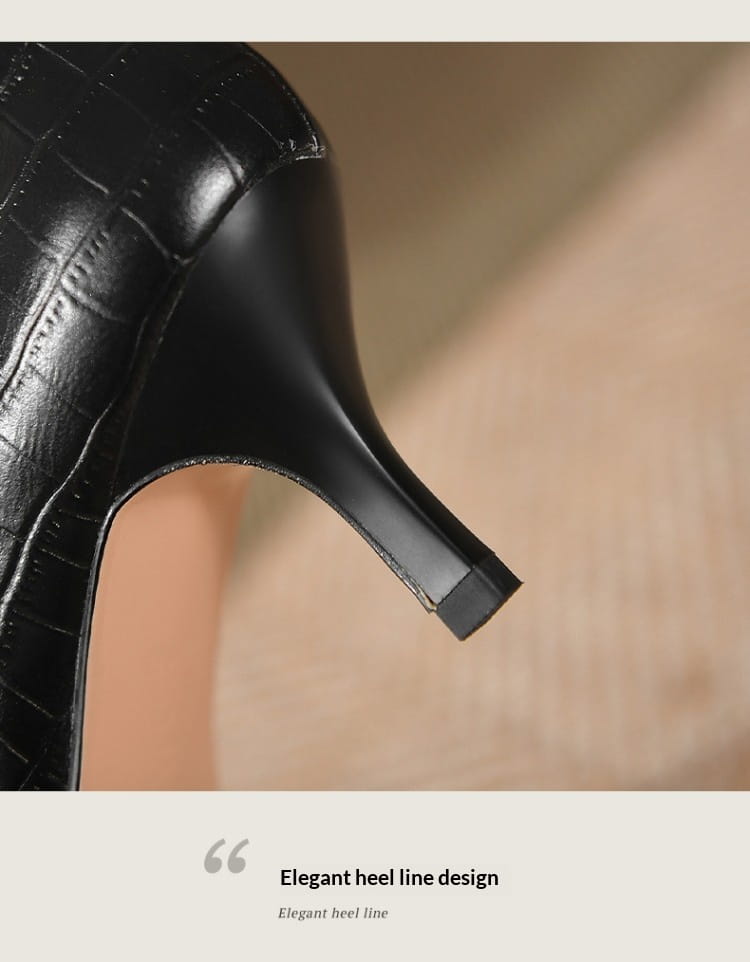 Black crocodile embossed leather stiletto ankle boot featuring a sleek elegant heel line shown from the back side.