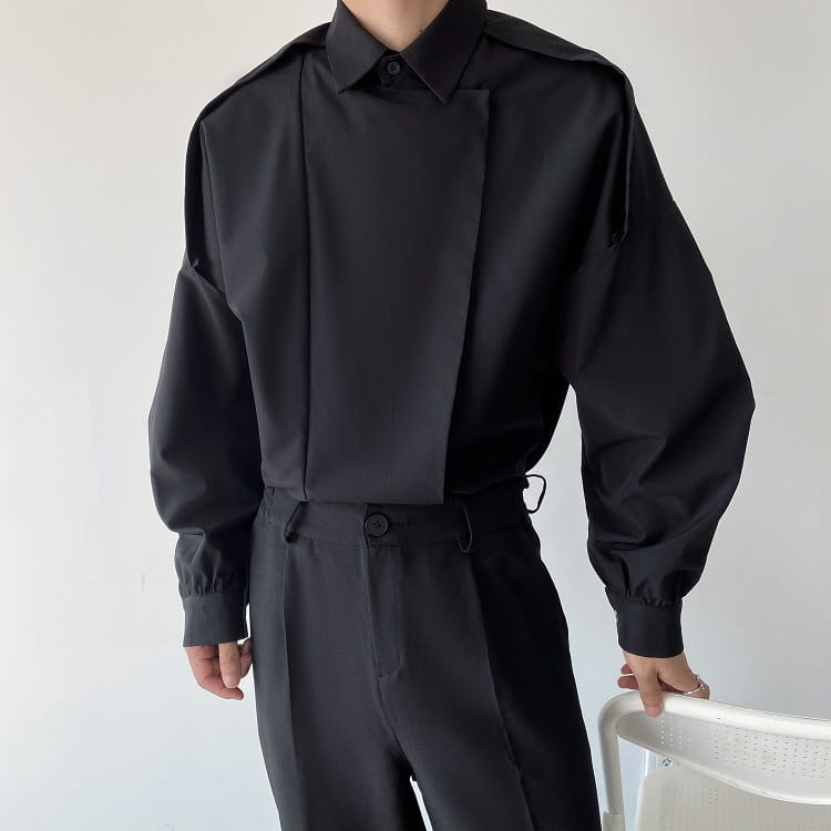 Black oversized long sleeve button up shirt for men with structured shoulders displayed from the front.