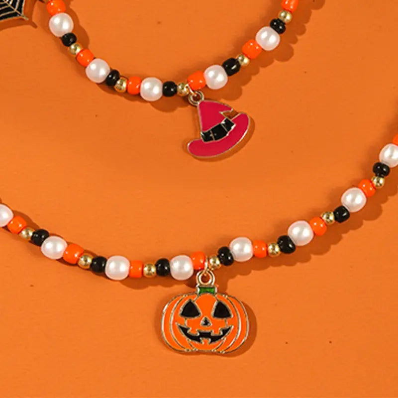 orange and black beaded halloween necklace featuring a pink witch hat charm from the halloween ghost and pumpkin beaded jewelry set
