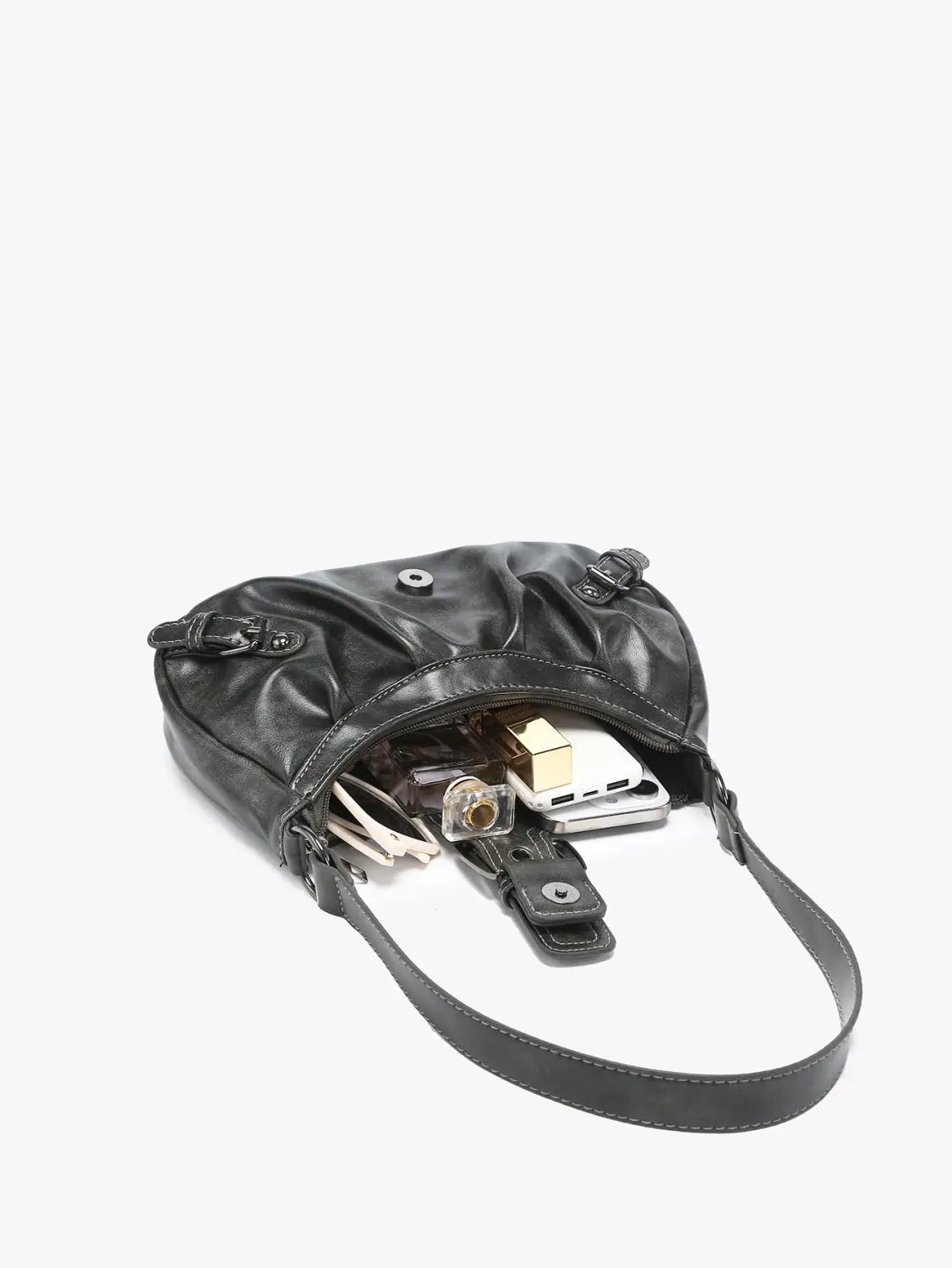 Black leather vintage shoulder bag with buckle details featuring a crossbody design with slanted top opening and adjustable strap.