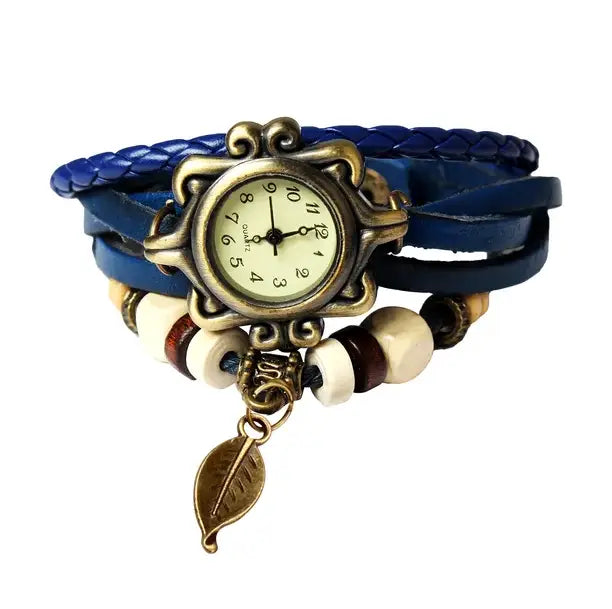 Bohemian blue braided leather leaf charm wrap watch with an ornate bronze-toned case and a dangling leaf charm.