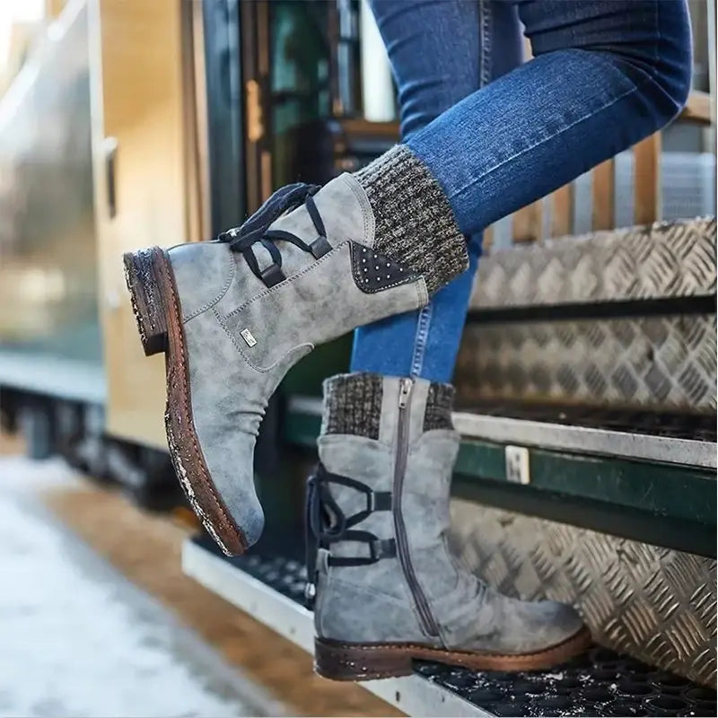 Gray suede women winter snow boots with black laces and a textured knit cuff designed for mid calf martin shoe style.