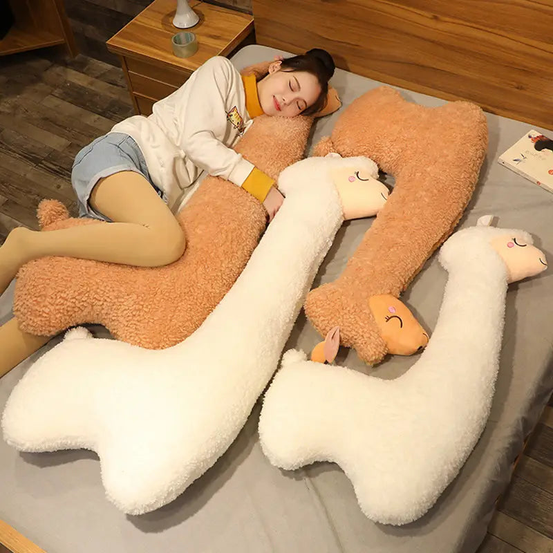 Soft plush tan and white alpaca-shaped body pillows with embroidered faces made from plush material in large 75cm size for comfortable use.