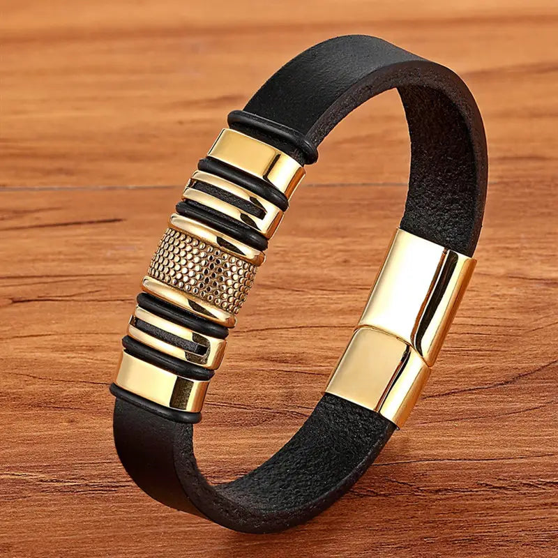 Black leather Scorpion bracelet featuring gold-tone metal accents, a textured central piece, and a gold magnetic clasp.