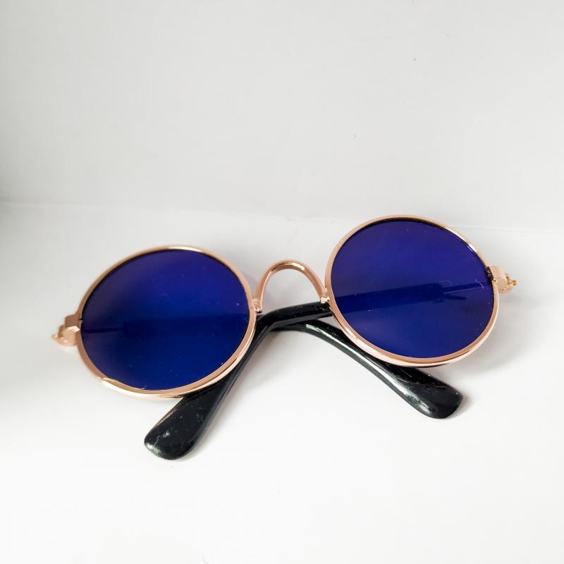 Rose gold metal round cat sunglasses with deep blue mirrored lenses and black temple arms.