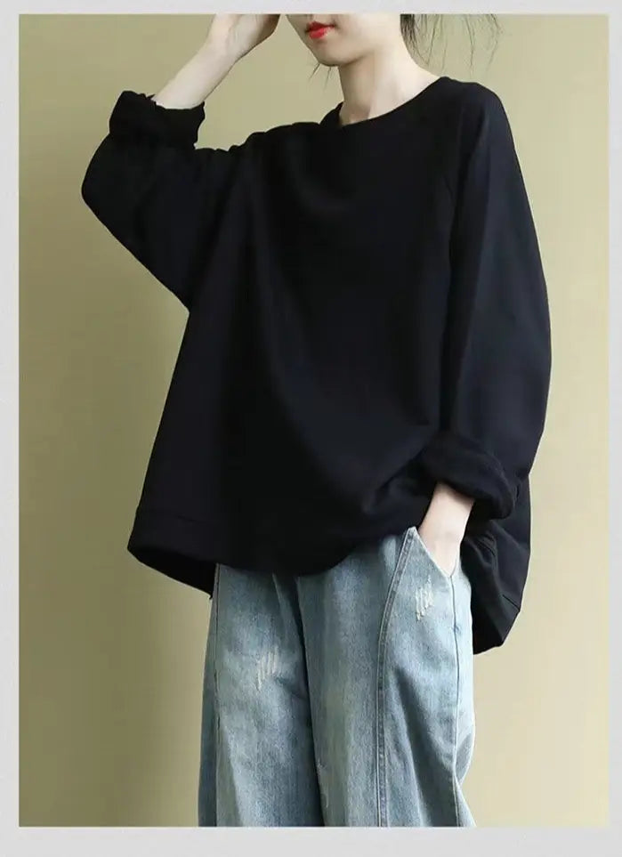 Black oversized long-sleeved pullover sweatshirt for women made of cotton blend with a relaxed fit and rolled cuffs.