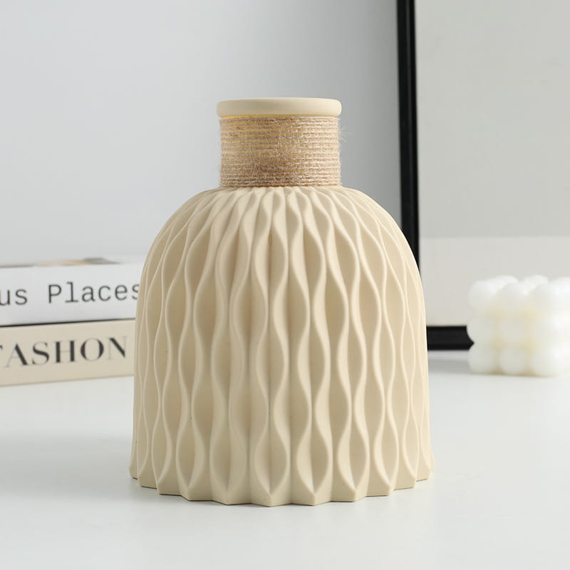 Cream-colored ceramic vase with a textured wavy pattern and a natural twine-wrapped neck from a ceramic vase set with twine and wavy texture 4 pack.