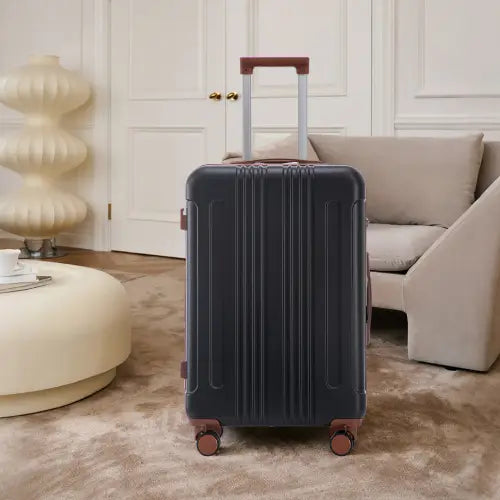 Dark navy hard-shell abs spinner suitcase with vertical ridges and copper-colored wheels and handle accents from the 3 piece abs spinner luggage set with TSA lock.