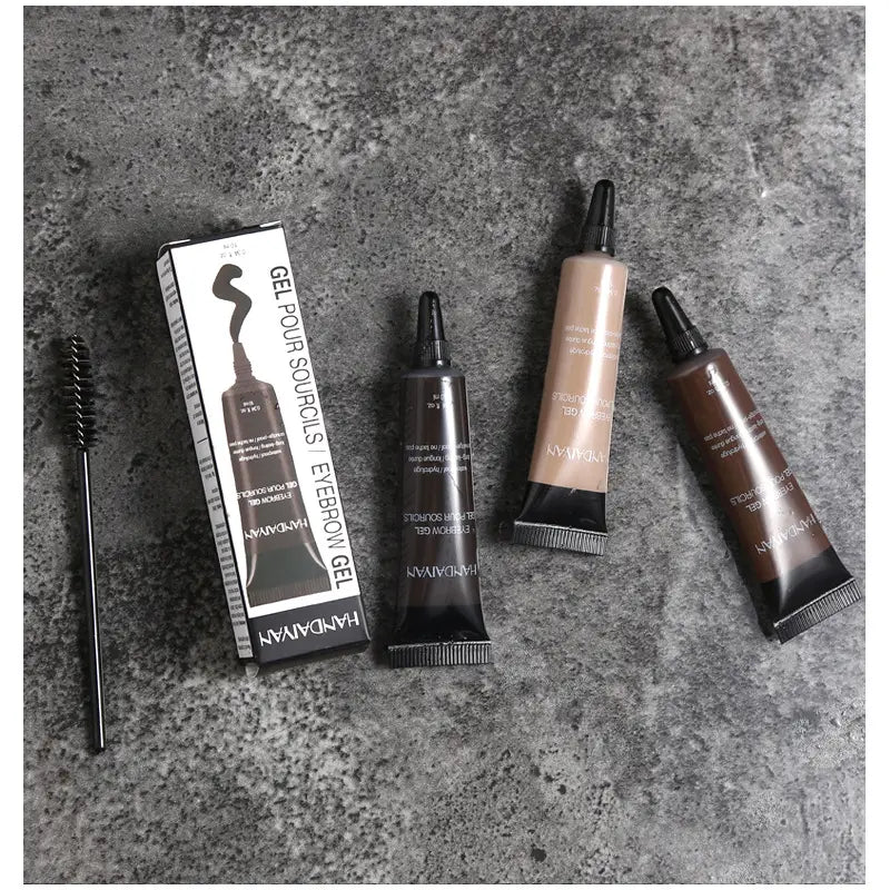 Three tubes of Handavian eyebrow henna gel waterproof liquid tint tattoo kit in black beige and brown are displayed with their packaging and a spoolie brush.