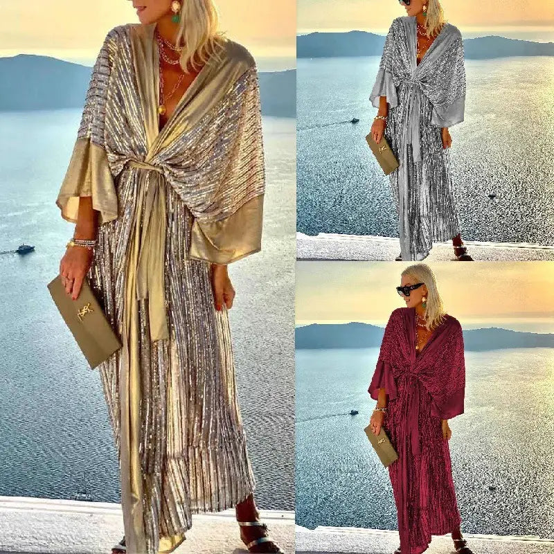 Metallic bat sleeve pleated sequin maxi dress in shimmering gold or silver with a draped front and pleated skirt.