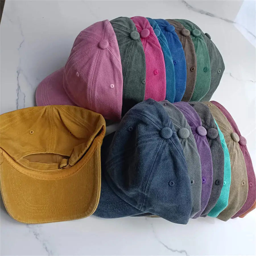a collection of colorful corduroy cotton baseball caps in pink green blue and mustard yellow featuring a vintage washed sun hat style