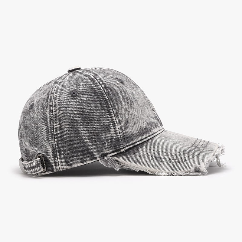 A distressed gray denim baseball cap with a frayed brim and an adjustable strap shown from the back side.