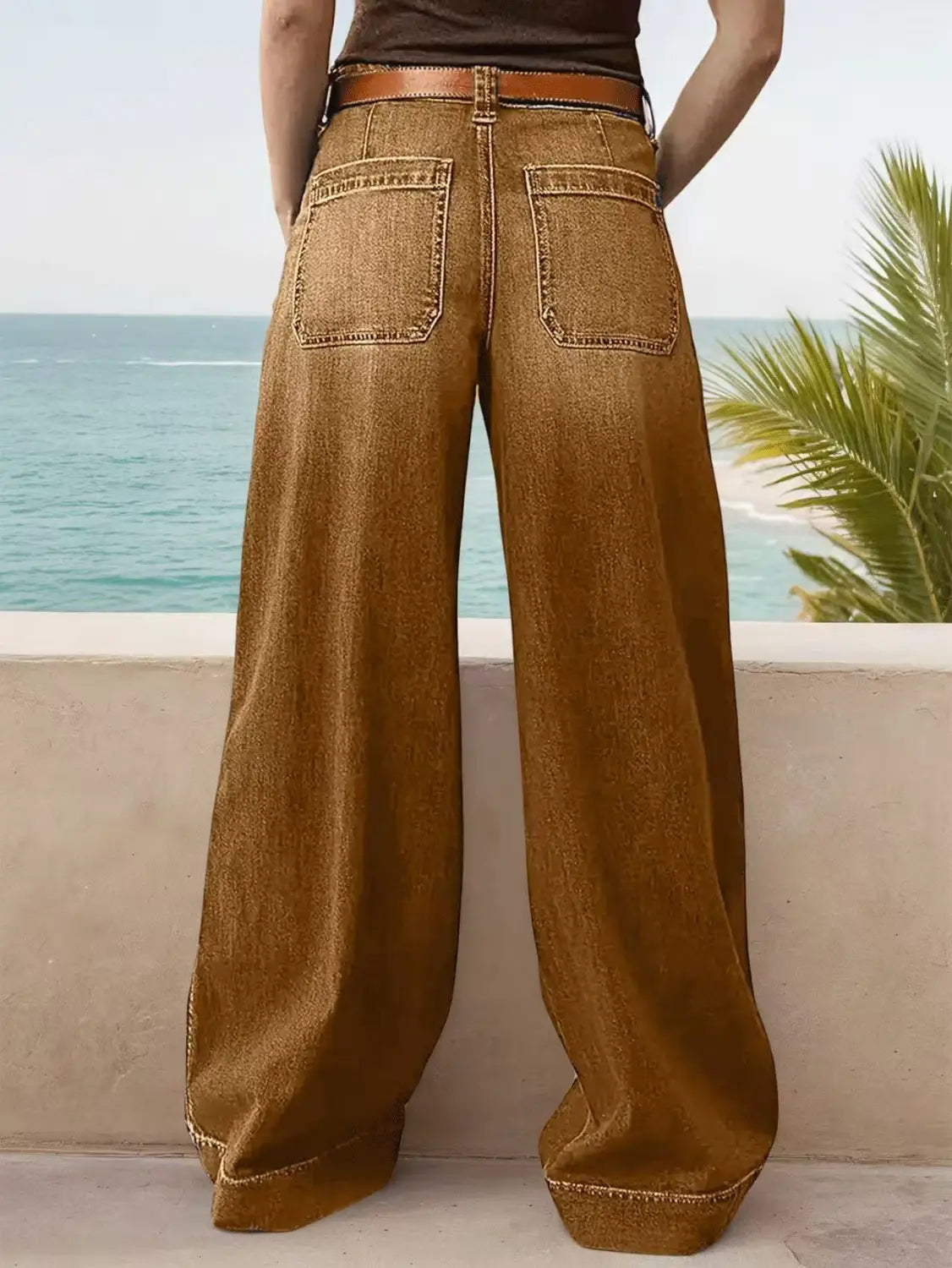 Wide leg denim pants with belt in brown denim featuring a relaxed fit and contrasting stitching.