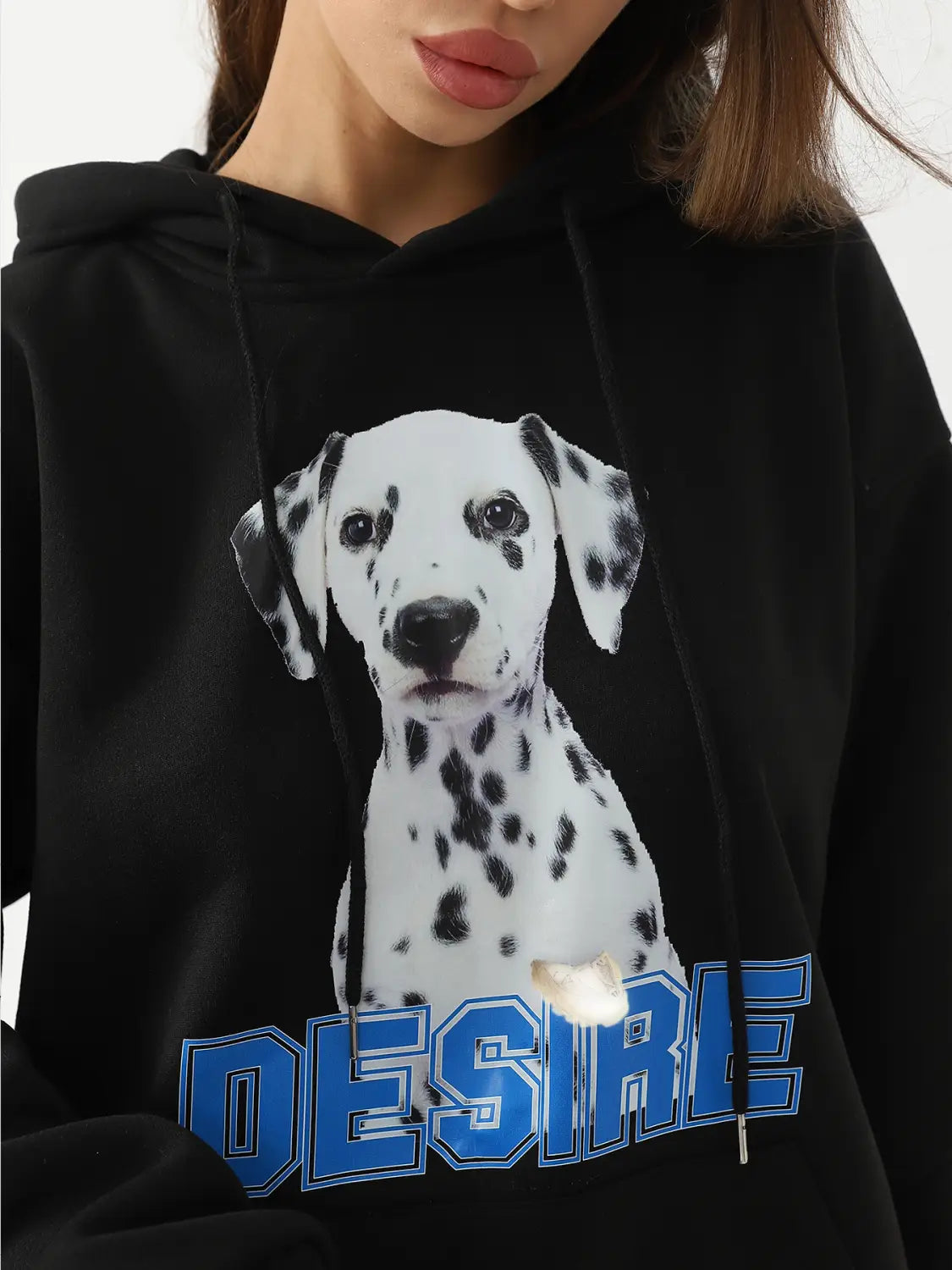 Black hoodie with cat ear hood featuring a large dalmatian puppy print with black spots and bold blue desire lettering on the chest for women