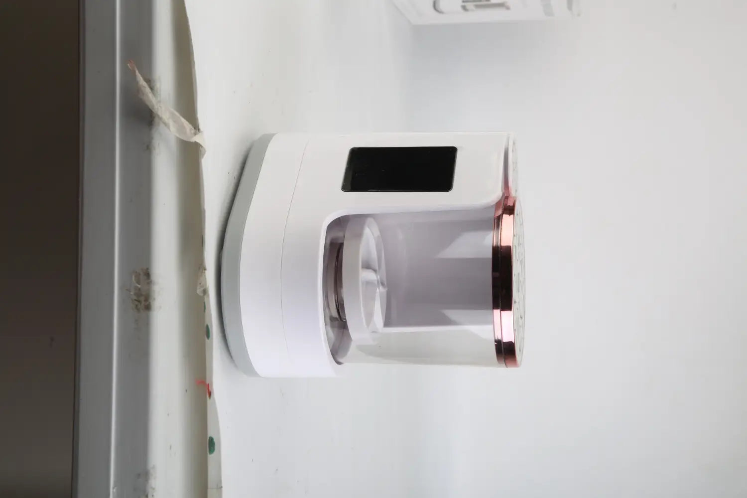 Electric makeup brush cleaner uv sterilizer and dryer in white and rose gold with a transparent cylindrical chamber for efficient brush cleaning and drying.