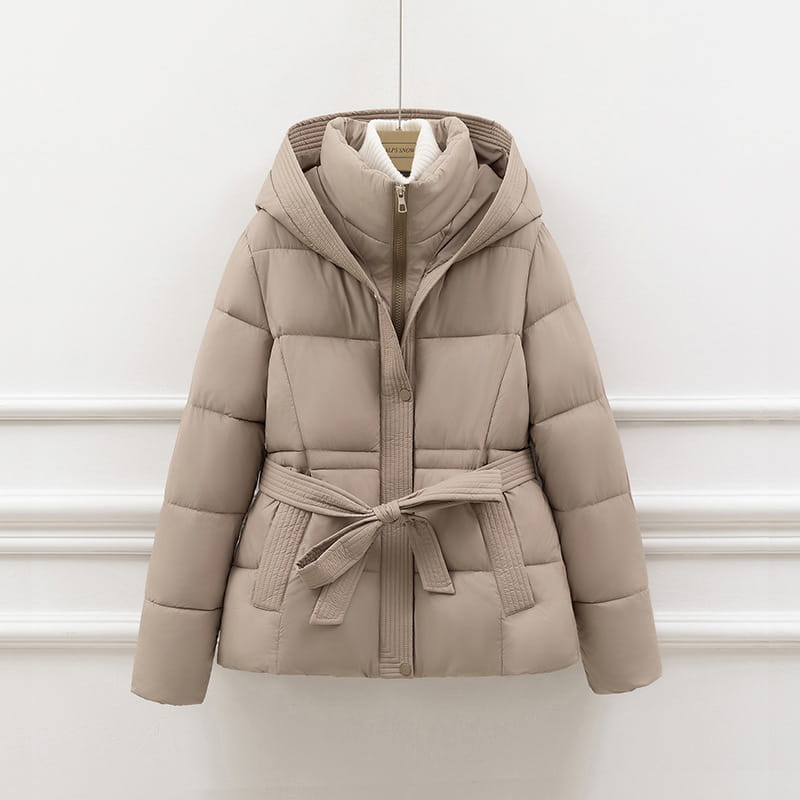 Beige quilted hooded winter puffer coat for women with a matching belt tied at the waist.