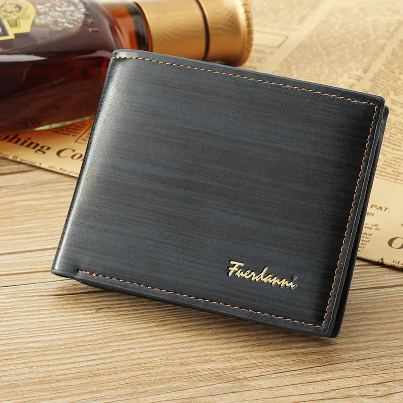 Men’s leather bifold wallet in black textured leather with gold stitching and subtle fuerdann logo embossed in gold featuring card slots and an ID window.