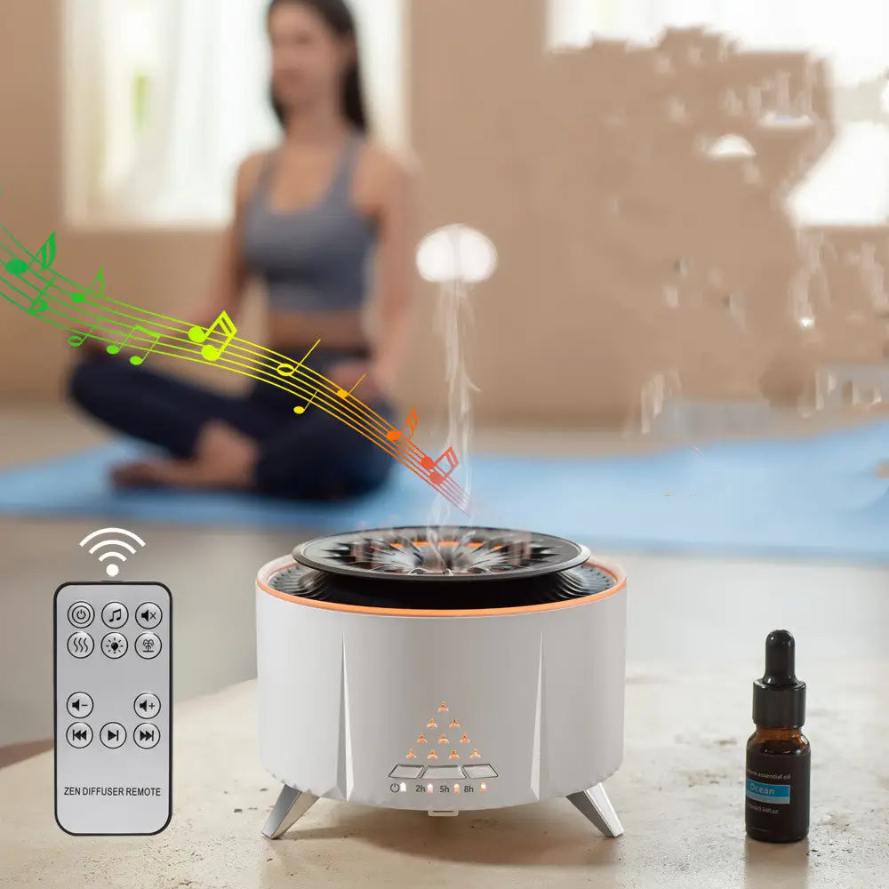 White cylindrical essential oil diffuser with orange accent trim and tripod legs emitting mist and displaying led timer indicators in the white noise flame aroma diffuser bluetooth humidifier.
