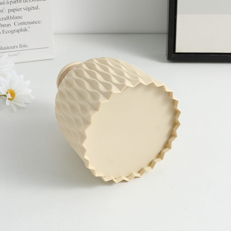 Beige ceramic vase with textured geometric pattern and scalloped rim from ceramic vase set with twine and wavy texture 4 pack.