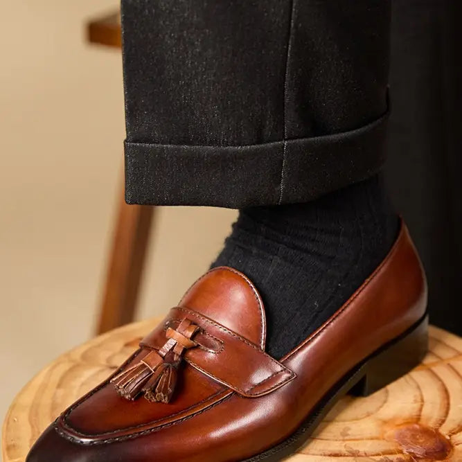 polished genuine leather tassel loafers in black patent leather with a glossy finish and classic design