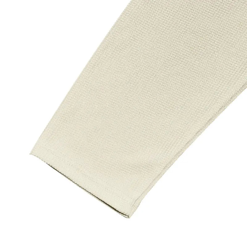 Beige textured fabric sleeve with a subtle woven pattern on a men’s long sleeve waffle knit thermal pullover.