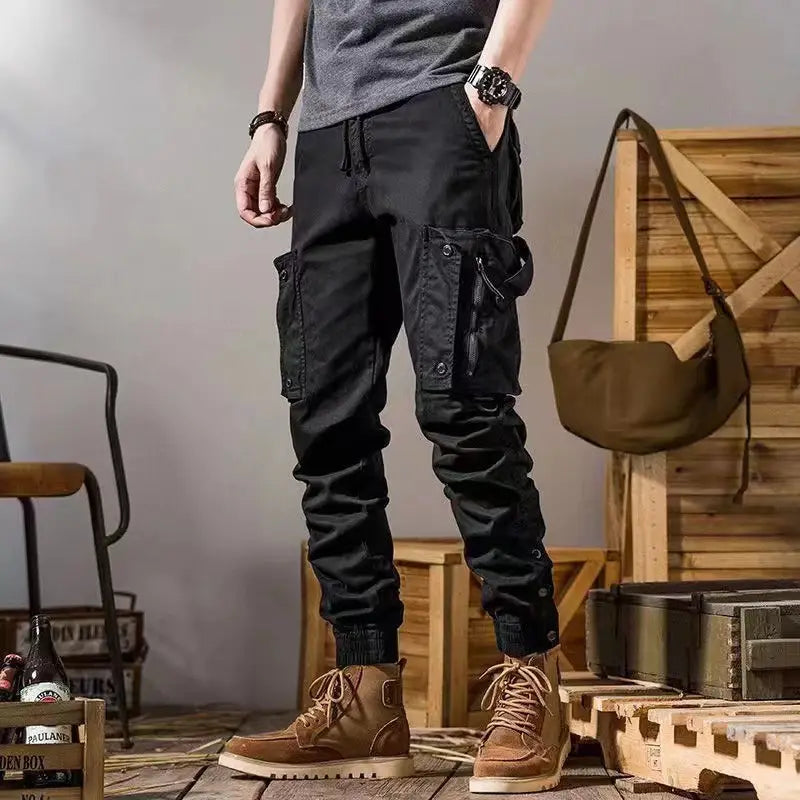men tactical cargo pants outdoor casual utility trousers in black with multiple pockets and a drawstring waistband designed for durability and functionality.