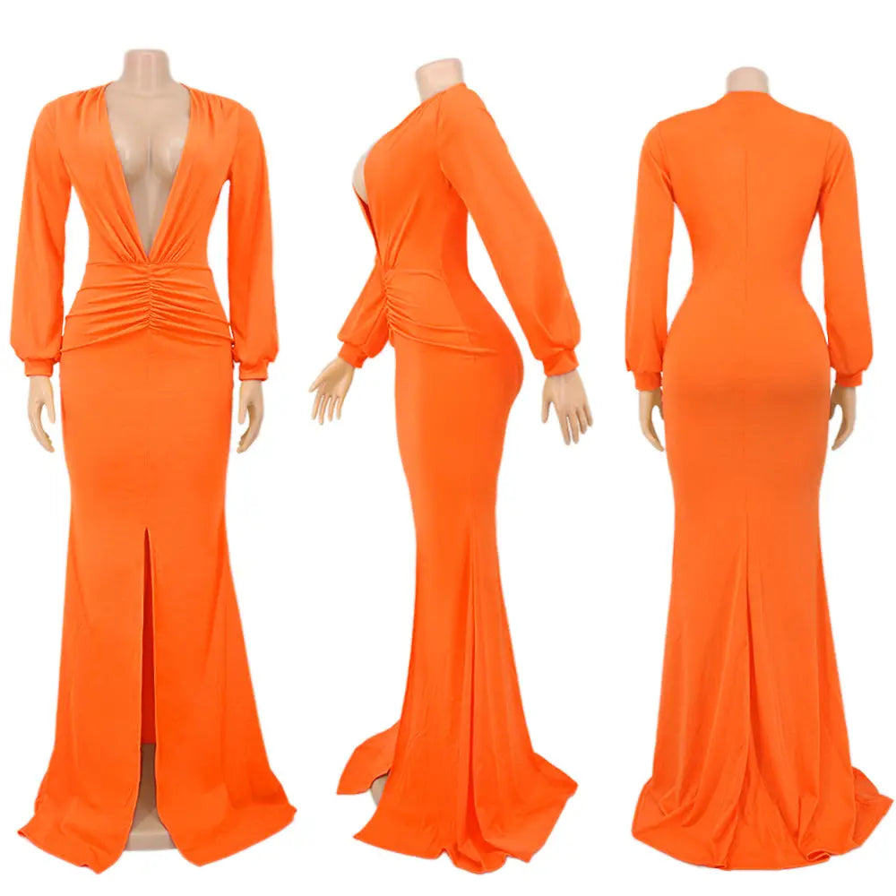Vibrant orange velvet v-neck evening dress featuring a long-sleeved mermaid silhouette with a deep v-neckline and ruched waist detail.