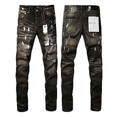 Men’s distressed slim fit patchwork denim jeans in black featuring a rugged worn-in look and reinforced stitching details.