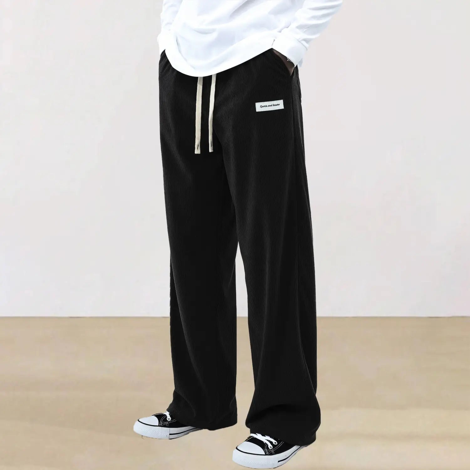 Men slim fit black corduroy wide-leg sporty drawstring casual pants with white drawstrings and a small rectangular label on the waistband.