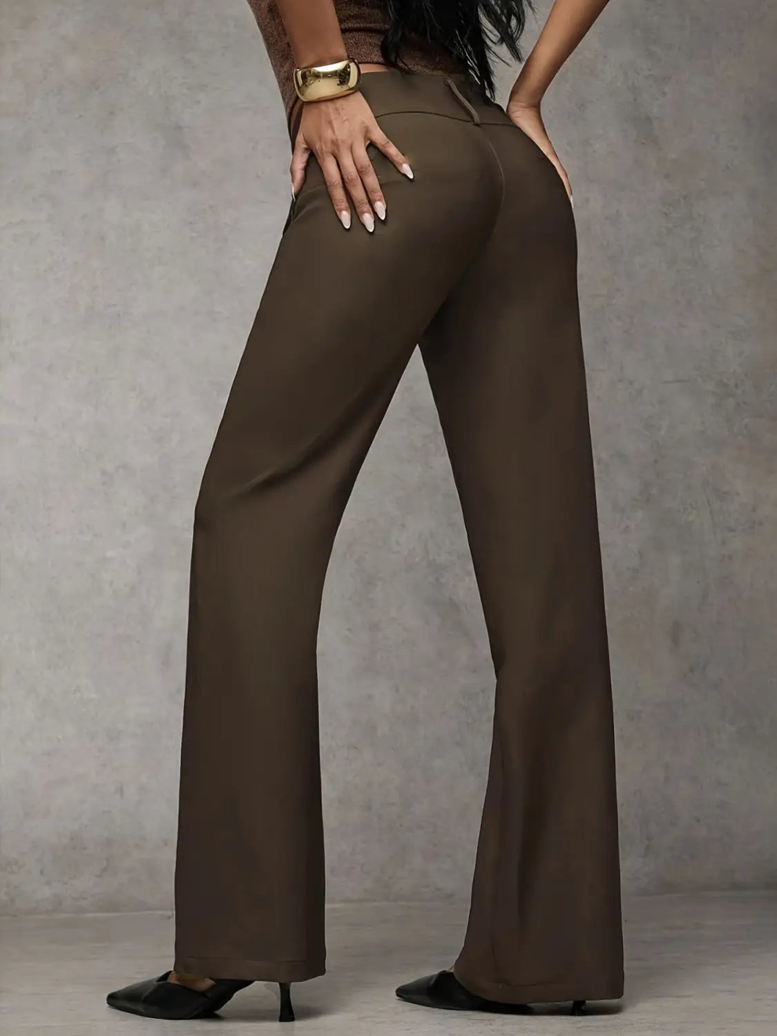 Brown wide leg work pants with a high waist and sleek tailored fit featuring subtle creasing for casual wear.