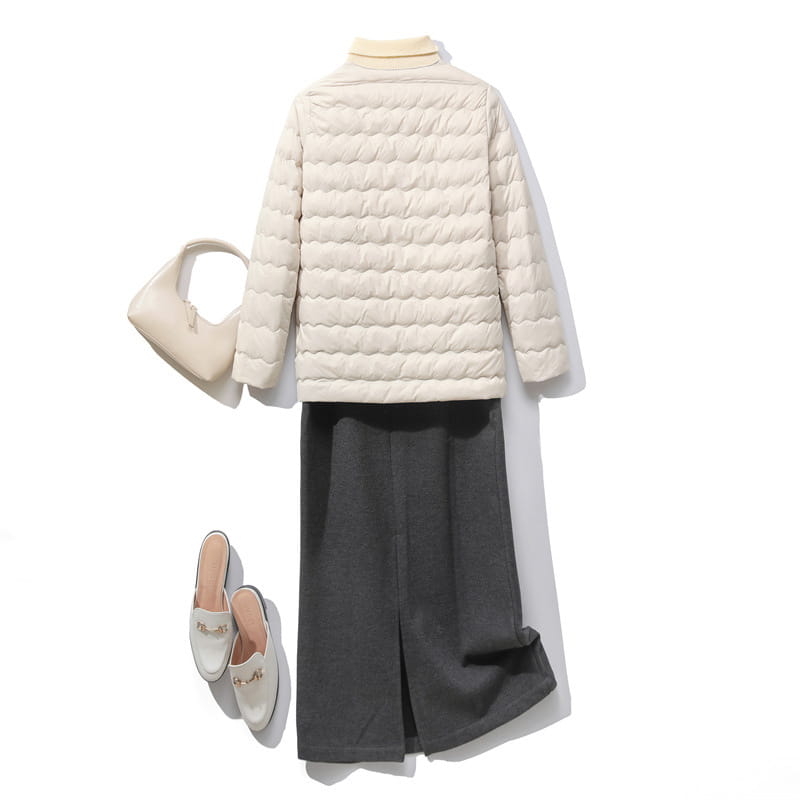 Cream-colored quilted puff jacket with a ruffled crew neck, high collar, and long sleeves.