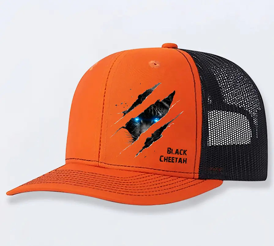 Bright orange cheetah graphic trucker hat for men featuring a black mesh back and front polyester panel with a black cheetahs face and glowing blue eyes peering through torn fabric.