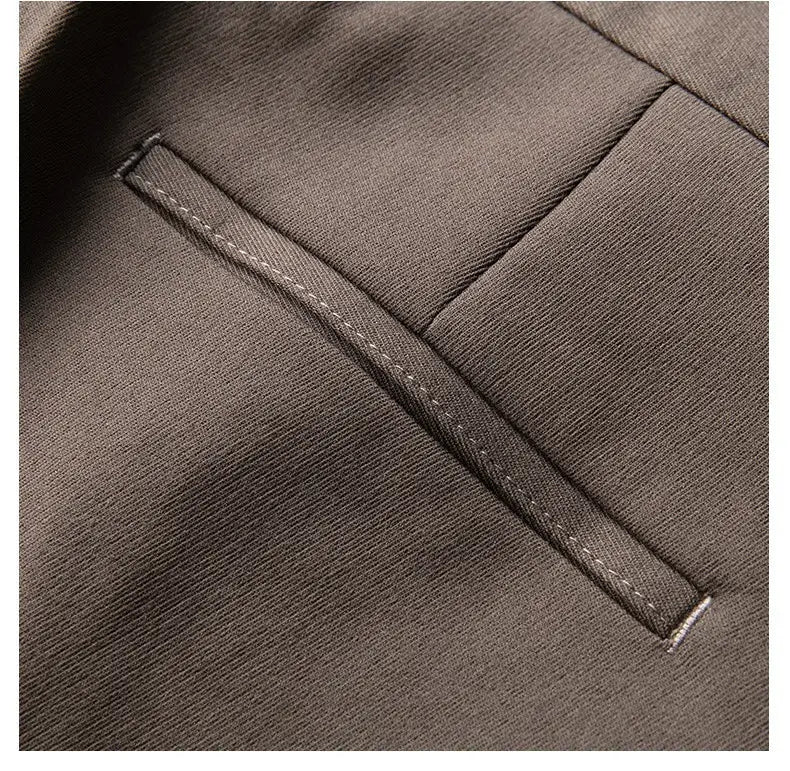 Men’s slim fit British style tailored straight leg trousers featuring a dark gray textured fabric pocket with precise white stitching along the edges.