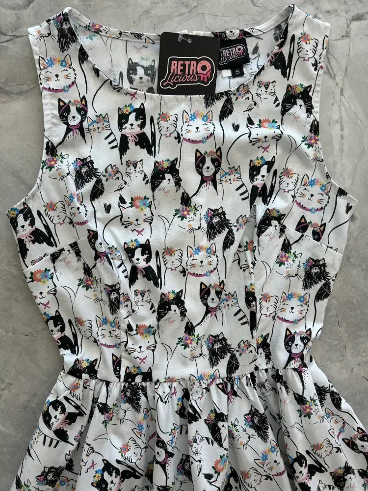 A white sleeveless cotton dress with black and multicolored floral crown cats by Retro Liquor vintage 1950s style