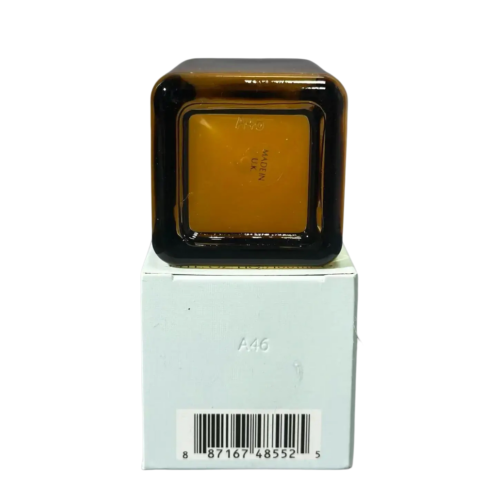 Amber glass face serum 100ml bottle with black rim and square shape resting on white box for skin care face use
