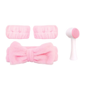 Pink plush microfiber headband set with bow design and matching pink silicone brush for facial clean routine