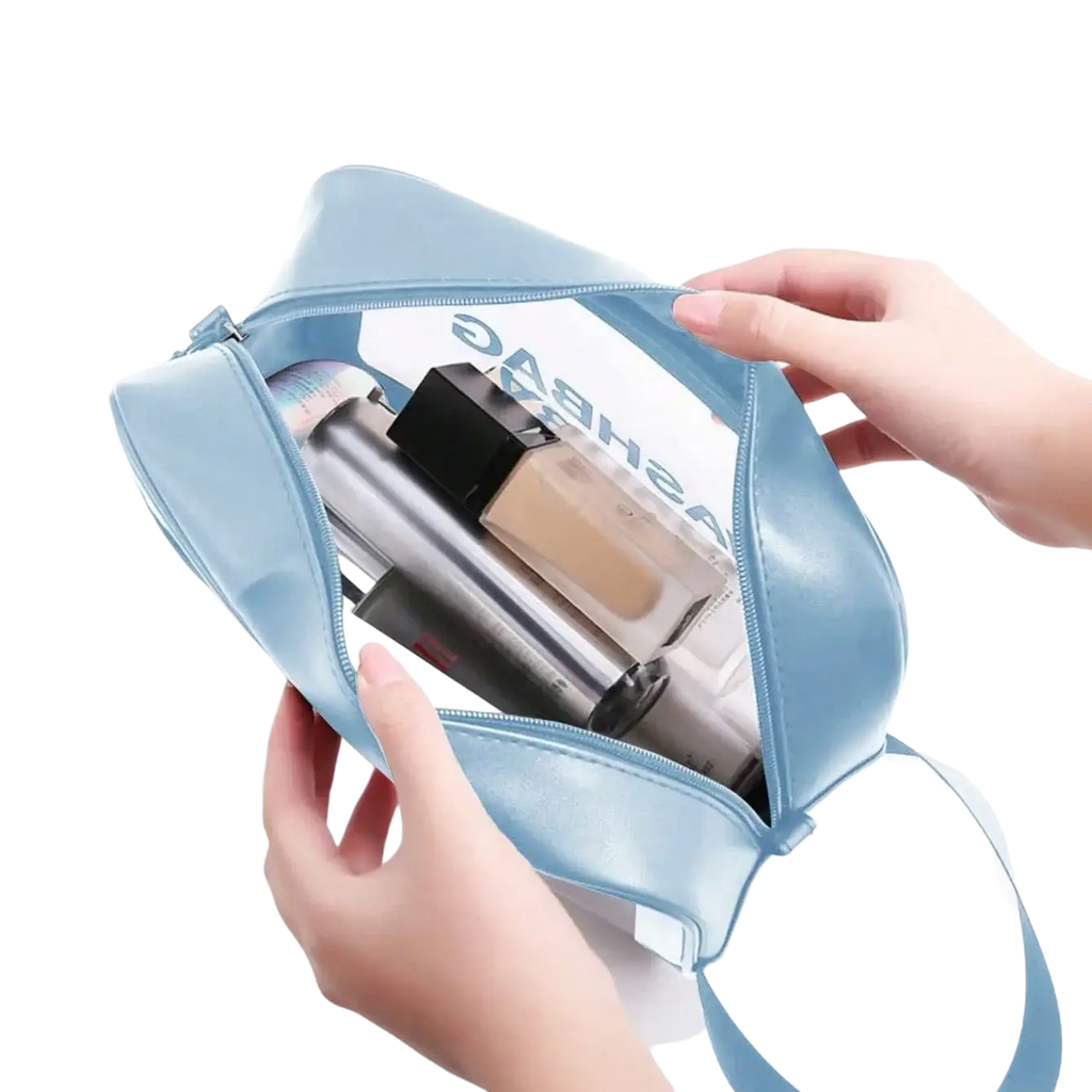 Light blue glossy fabric makeup bag with transparent front panel and adjustable strap for facial cleansing brush set