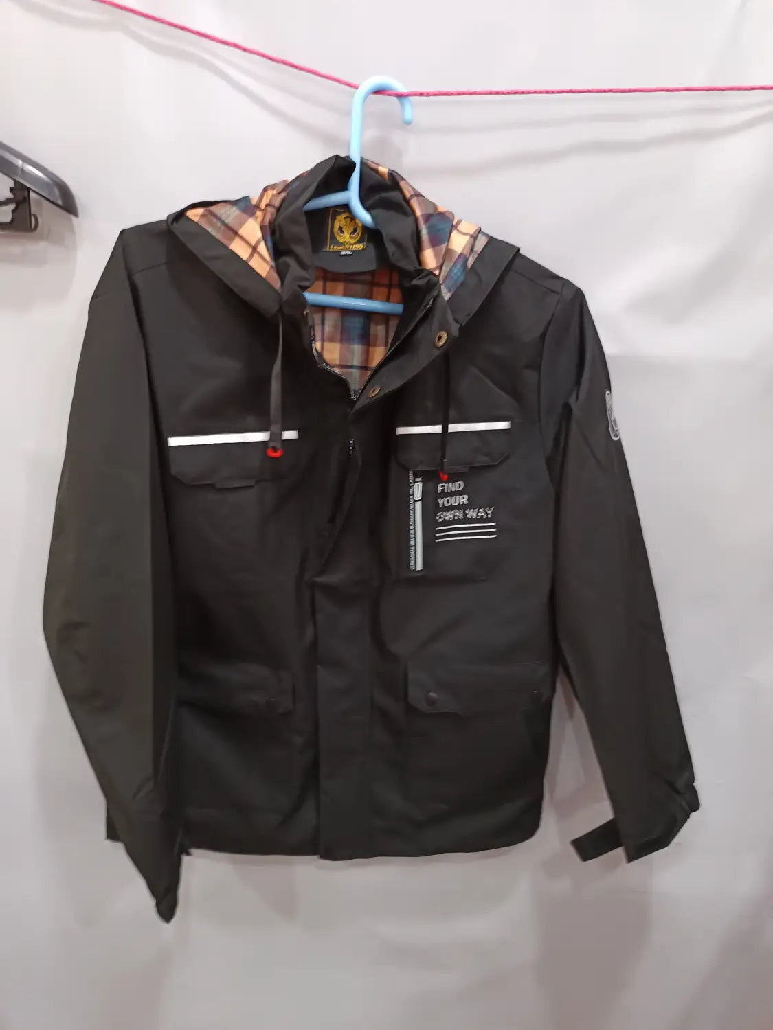 Men winter hooded parka coat in black with plaid lining white horizontal stripes on the chest and a find your own way patch.