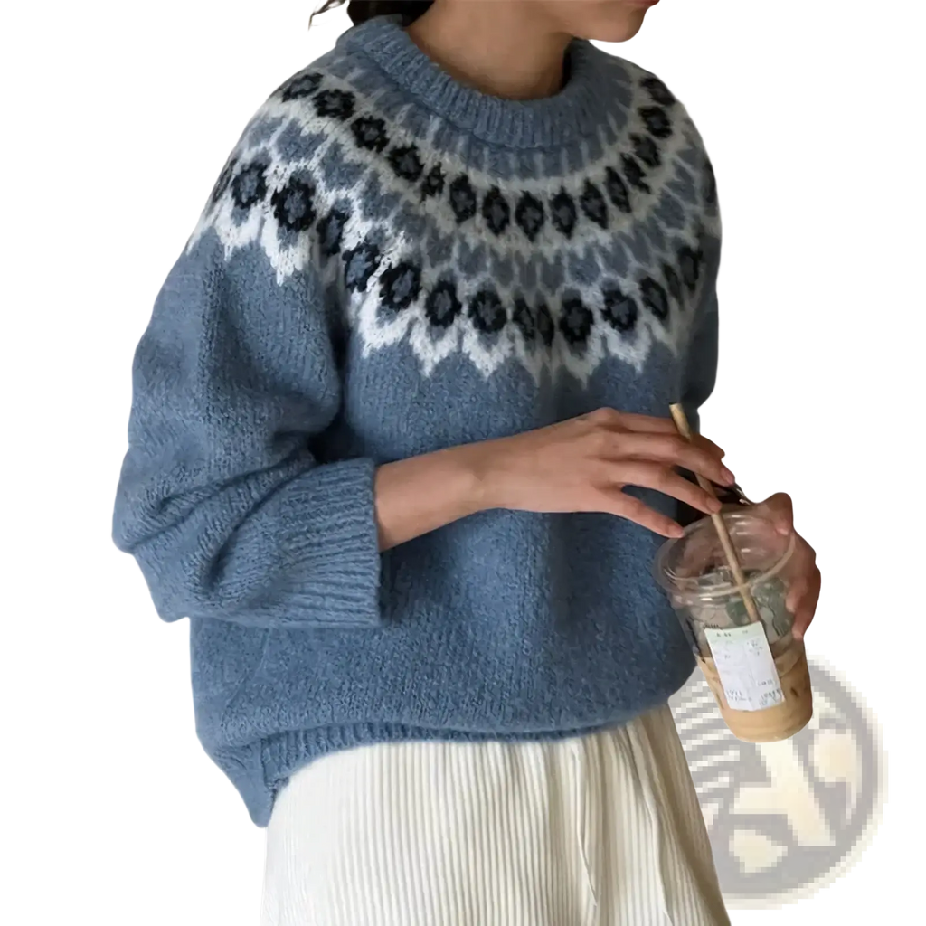 A cozy light blue fair isle geometric knit sweater with white and dark gray nordic pattern on the chest