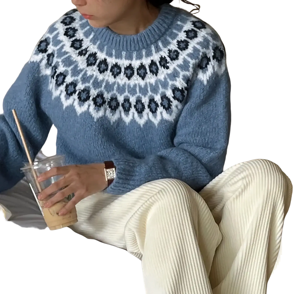 A cozy light blue fair isle geometric knit sweater with white and dark gray pattern across the chest