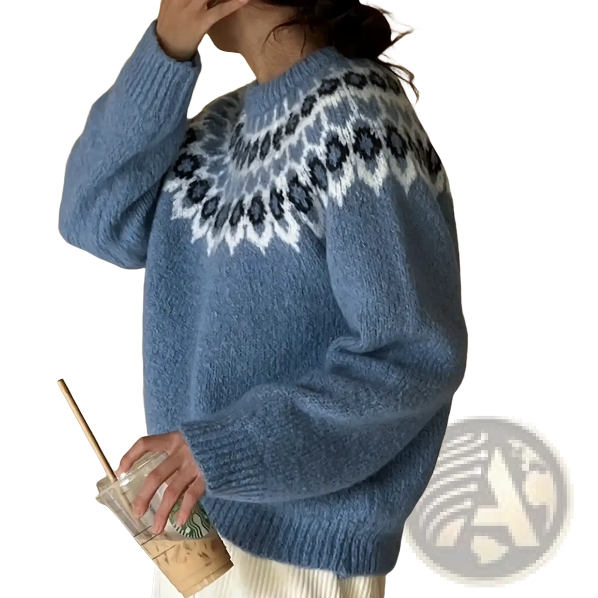 A cozy light blue fair isle geometric knit sweater with white and dark gray pattern across the shoulders