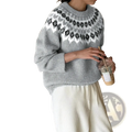 A cozy gray fair isle geometric knit sweater with a white and black pattern around the neckline