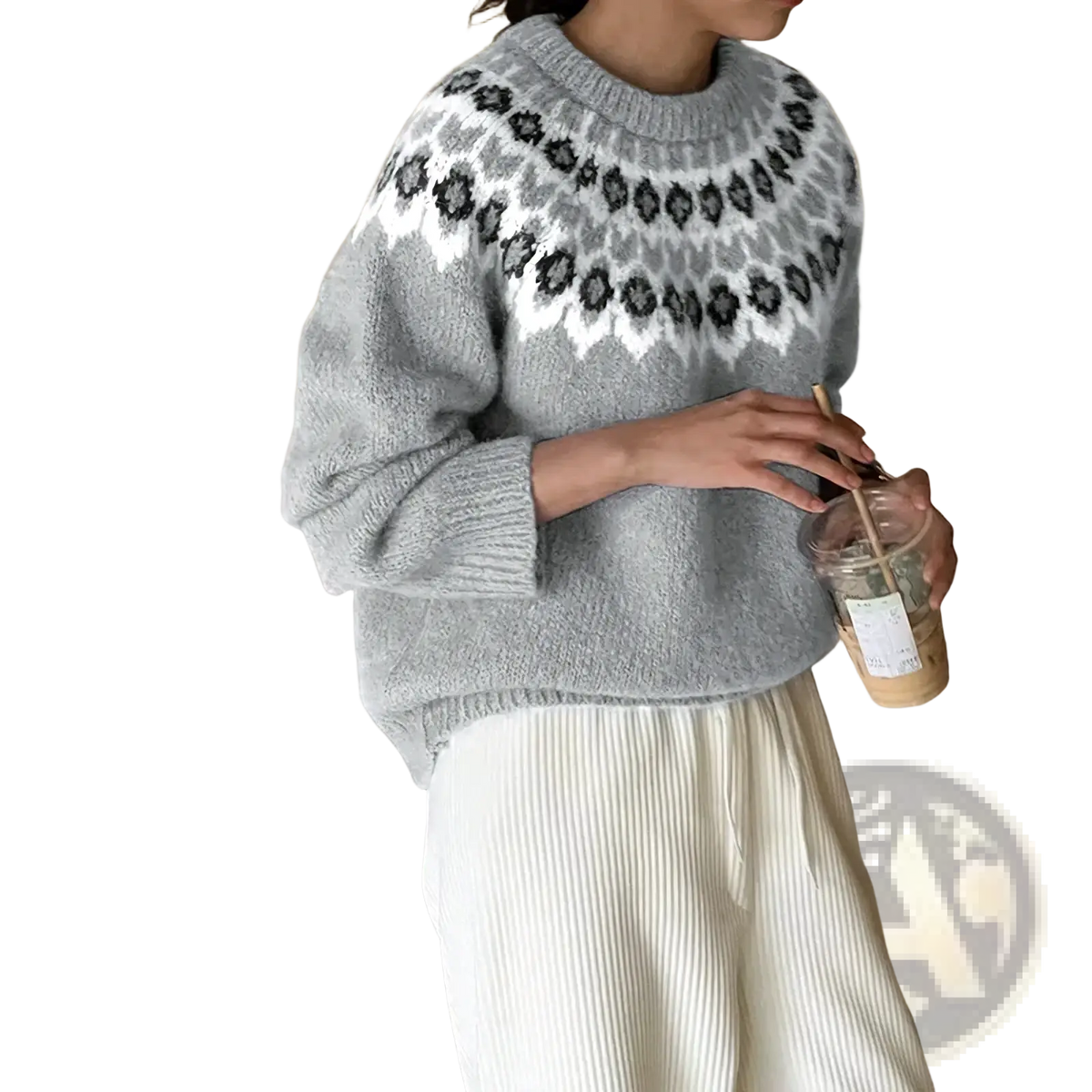 A cozy gray fair isle geometric knit sweater with a white and black pattern around the neckline