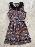 A sleeveless dark gray cotton fairies retro A-line dress with black peter pan collar and pink gold fairy rabbit print