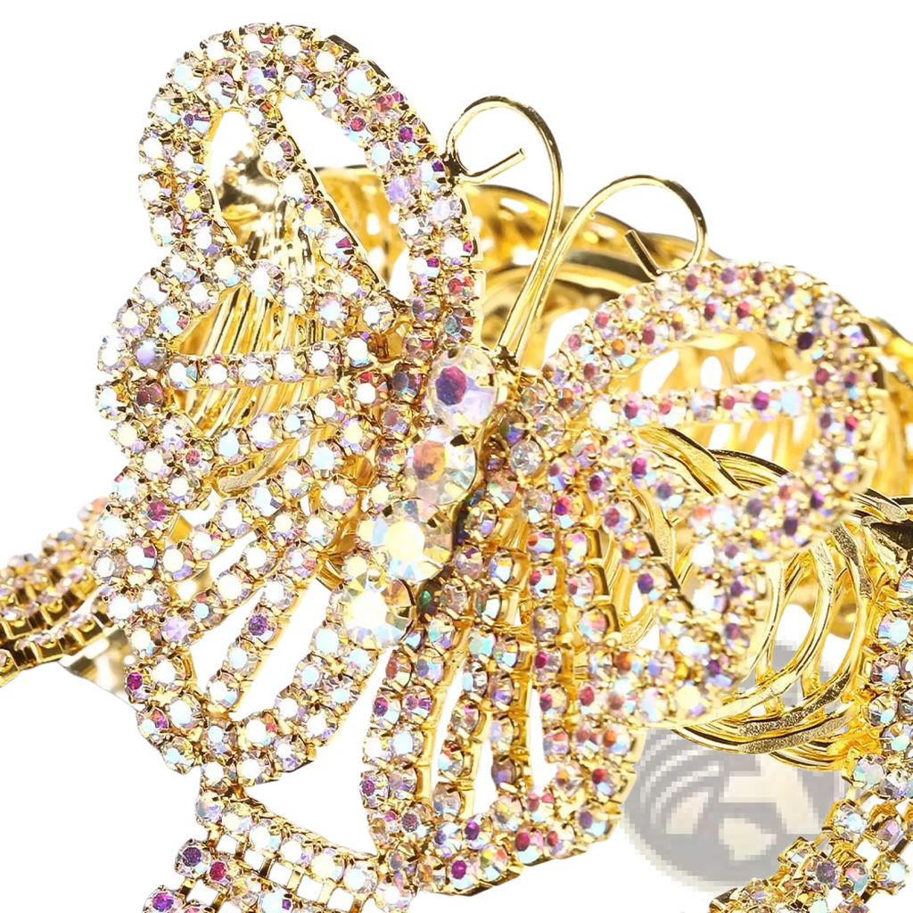 A sparkling gold butterfly-shaped rhinestone bracelet with iridescent rhinestones and tassel details