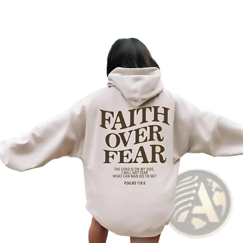Back side of a cream-colored oversized christian hoodie with bold brown faith over fear text and psalm 118 6 verse