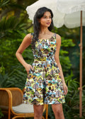 Folk art farm print sleeveless skater dress with pockets featuring a vibrant yellow green and blue chicken pattern