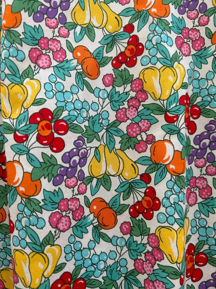 Farmer’s Market fruit print cotton skater skirt with vibrant yellow pears orange peaches red cherries purple grapes on cream