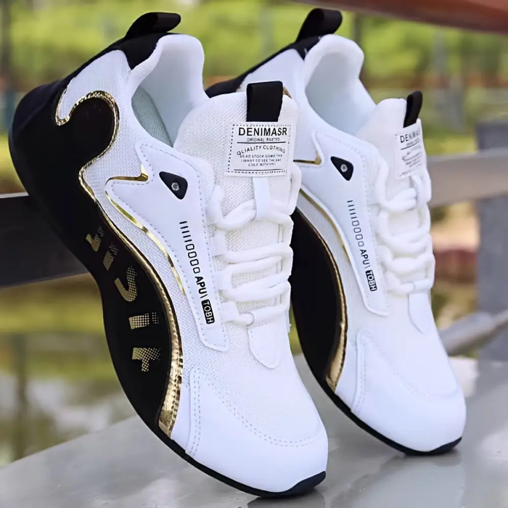 Men’s colorblock breathable mesh sport sneakers in white and black with gold accents and a rubber sole
