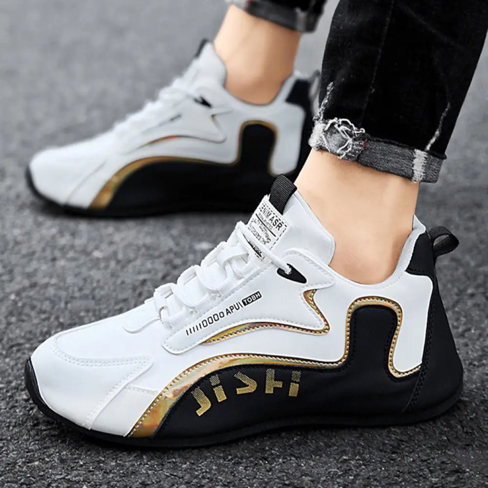 Men’s colorblock breathable mesh sport sneakers in white and black with gold accents and jishi branding on the side